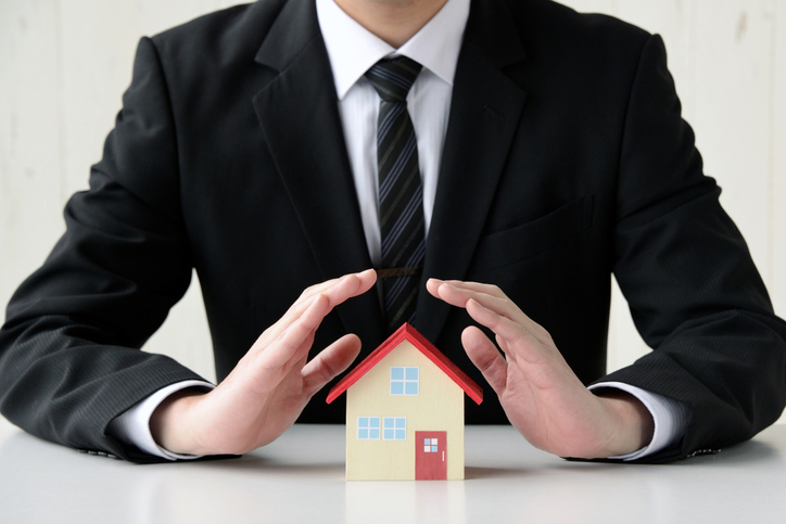 Business man saving house problems